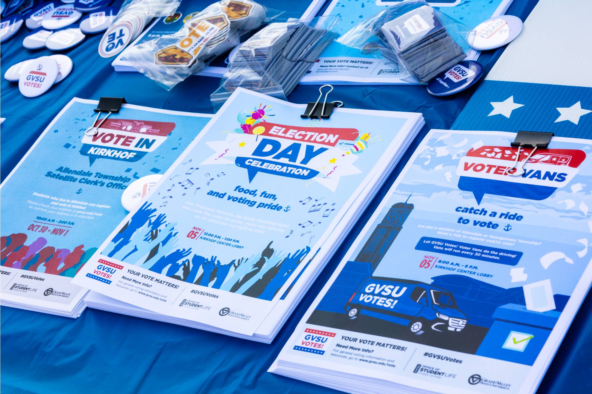 Three stacks of "GVSU Votes!" pluggers